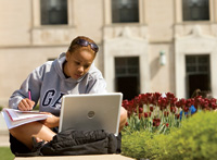 student outside Rackham School of Graduate Studies